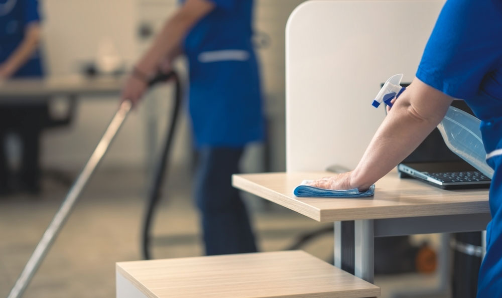 Cleaning,An,Office,Table.other,Cleaners,Clean,In,The,Background